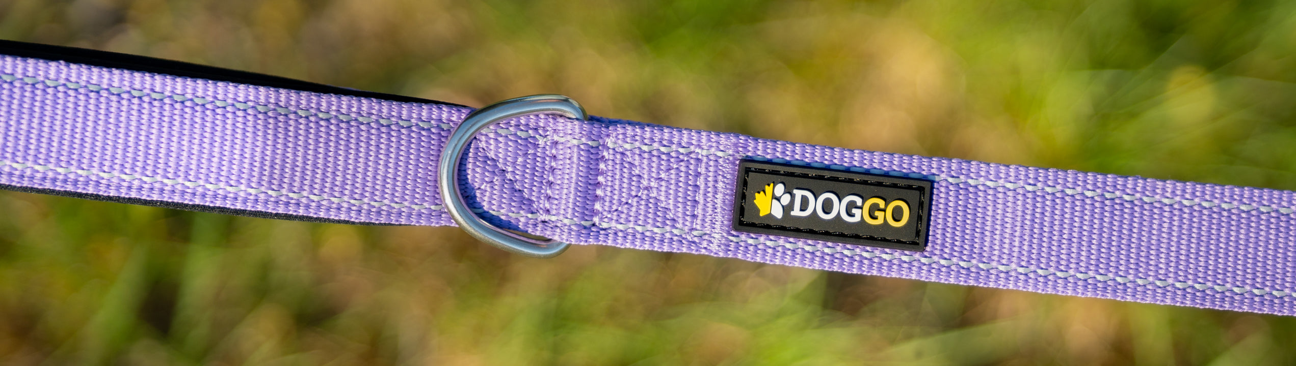 The DogGo logo and wordmark on a DogGo Adjustable Padded Leash, in wild lavender.